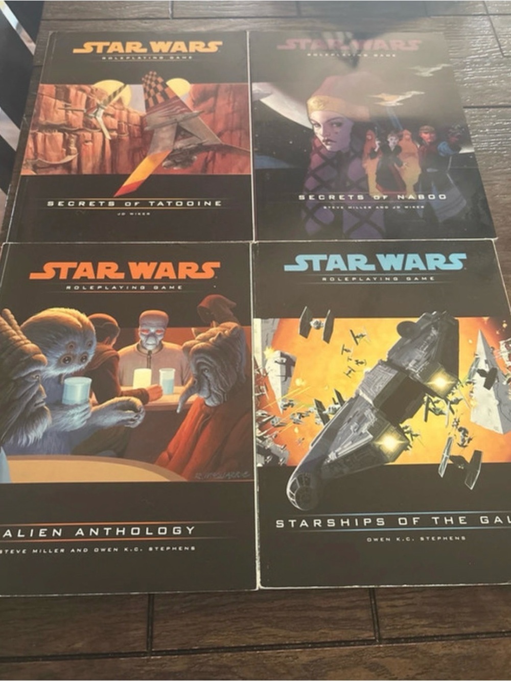 Star Wars Roleplaying Game Books with Black, Orange, Blue Cover Art